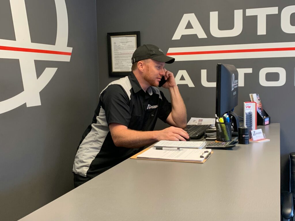 Automotive service advisor taking a customer call